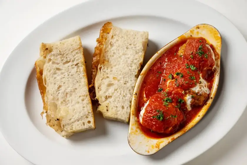 Baked meatballs in tomato sauce with toasted focaccia