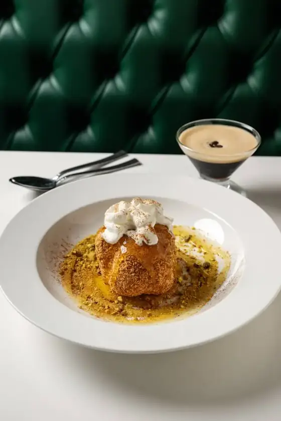 Baklava fried ice cream with whipped cream and pistachios beside an espresso martini