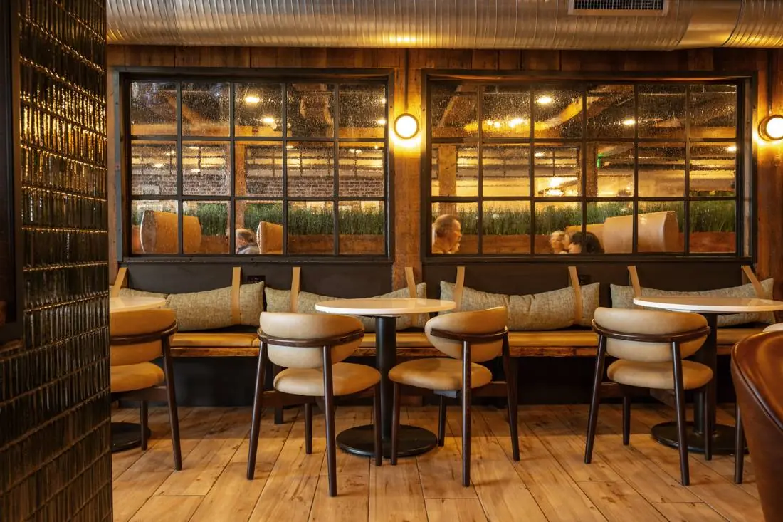 Banquette and table seating along large windows