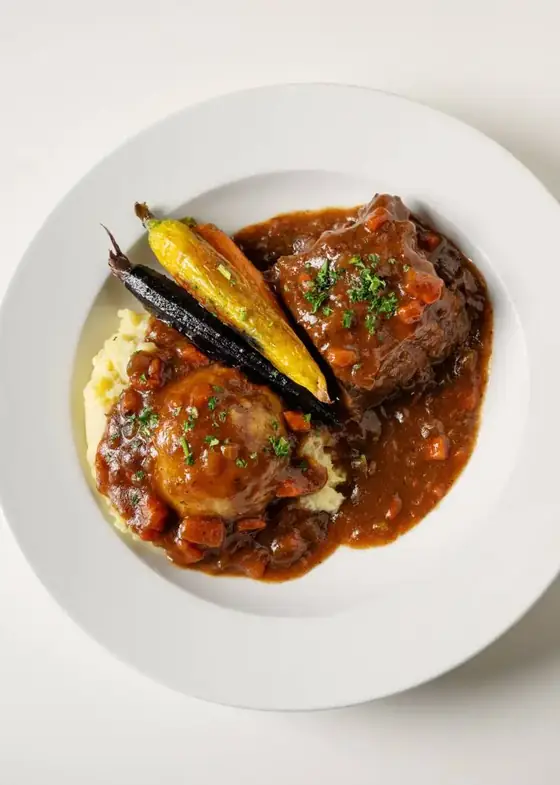 Braised short rib over mashed potatoes with roasted carrots