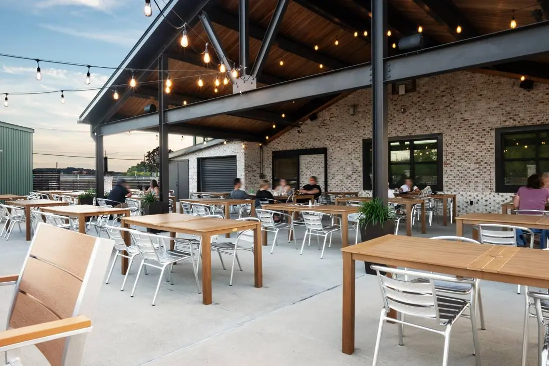 The covered patio with string lights and outdoor tables