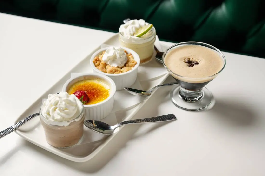 A dessert flight of mini desserts with an espresso martini