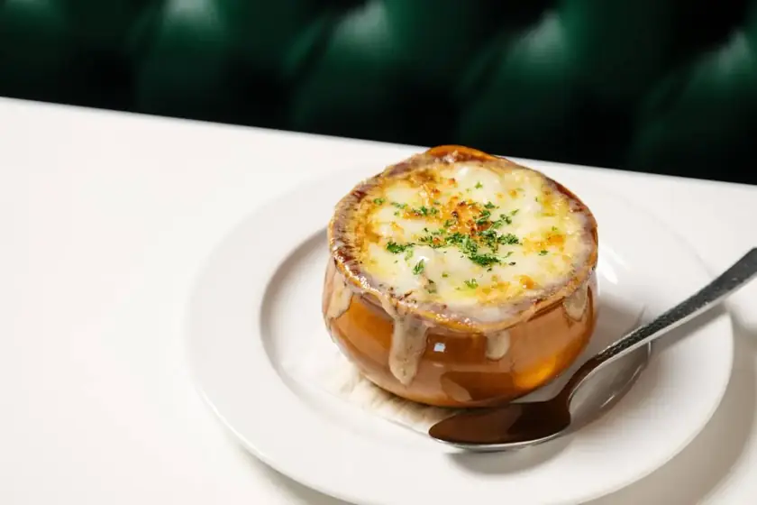 French onion soup in a crock under melted, browned cheese